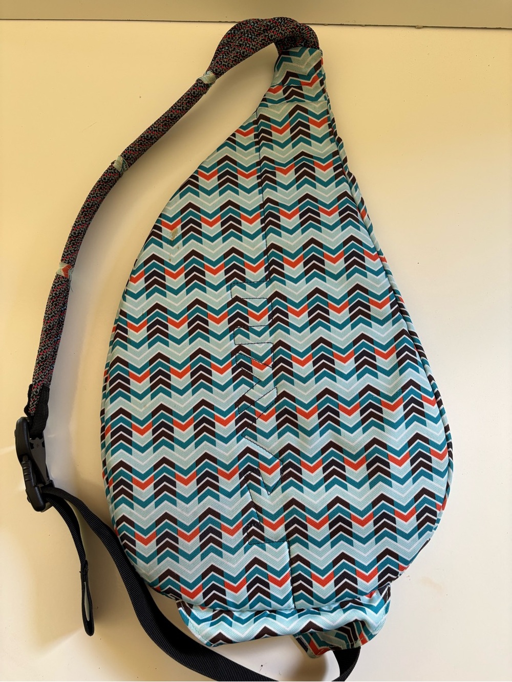 Kabu Chevron Teardrop Sling Backpack in Aqua, Black & Orange